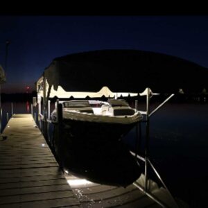 Single boat lift canopy light night view from the dock