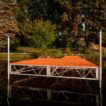 end view of patio truss frame dock with brown aluminum decking